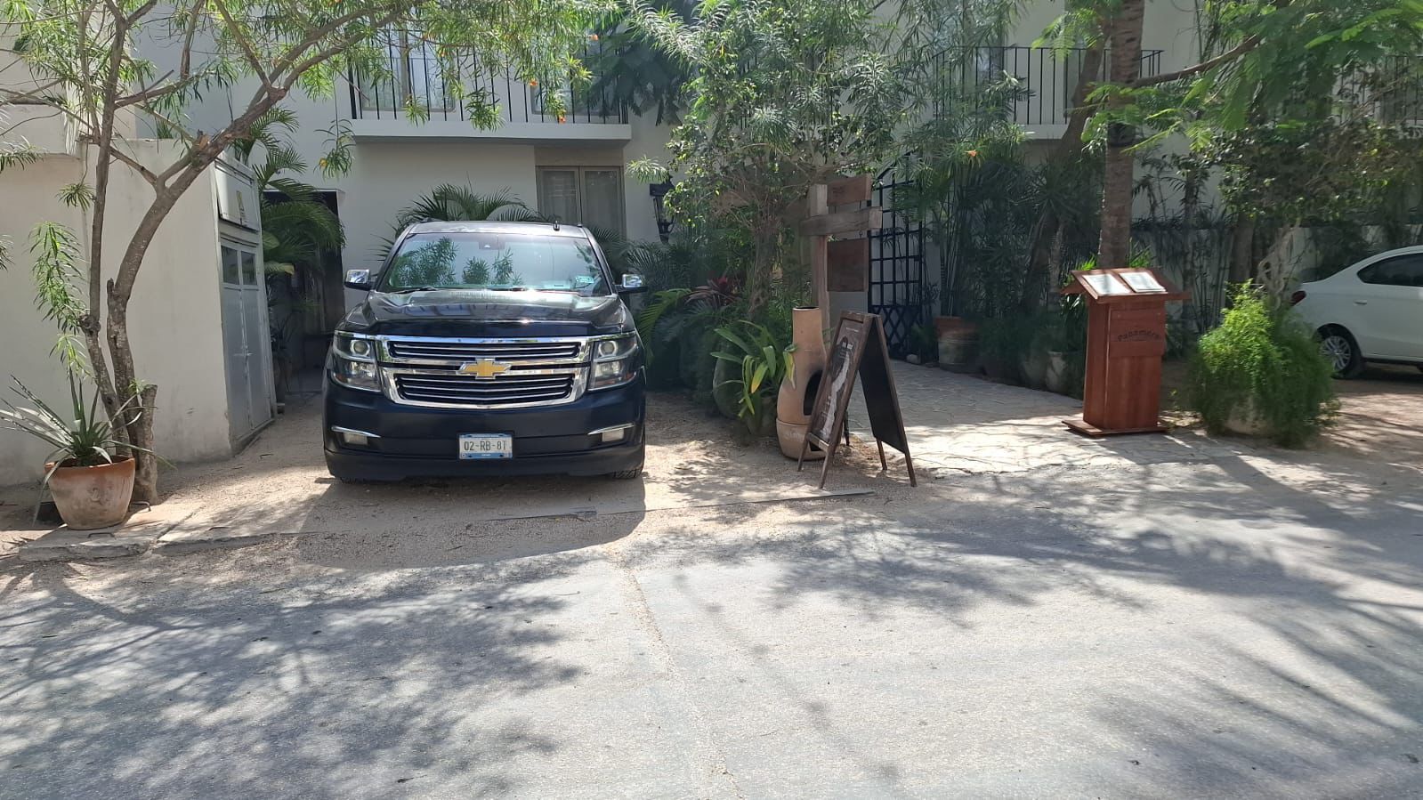 Black Chevrolet Suburban at a resort driveway prepared for guest arrivals and private transportation.